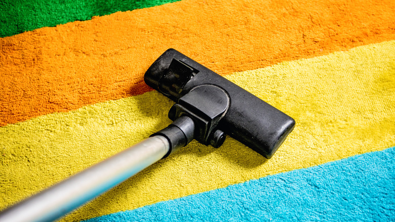 Vacuuming colorful striped carpet