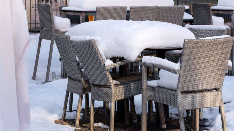 Patio table and chairs covered in snow