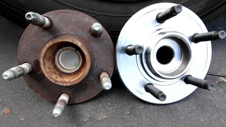 A side-by-side comparison of a worn-out sealed bearing and a new one and hub assembly and a new version