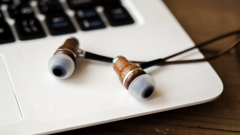 Closeup of Symphonized earbuds resting on a laptop