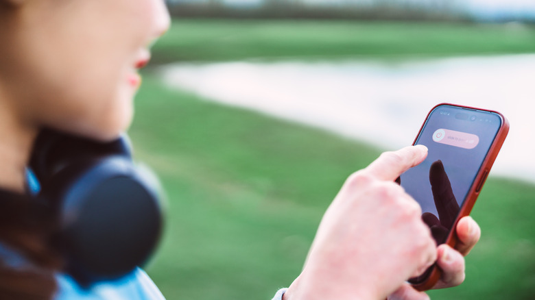 Woman turning off iPhone