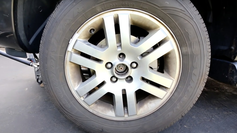 Mercury Mountaineer with front wheel center cap removed exposing axle nut